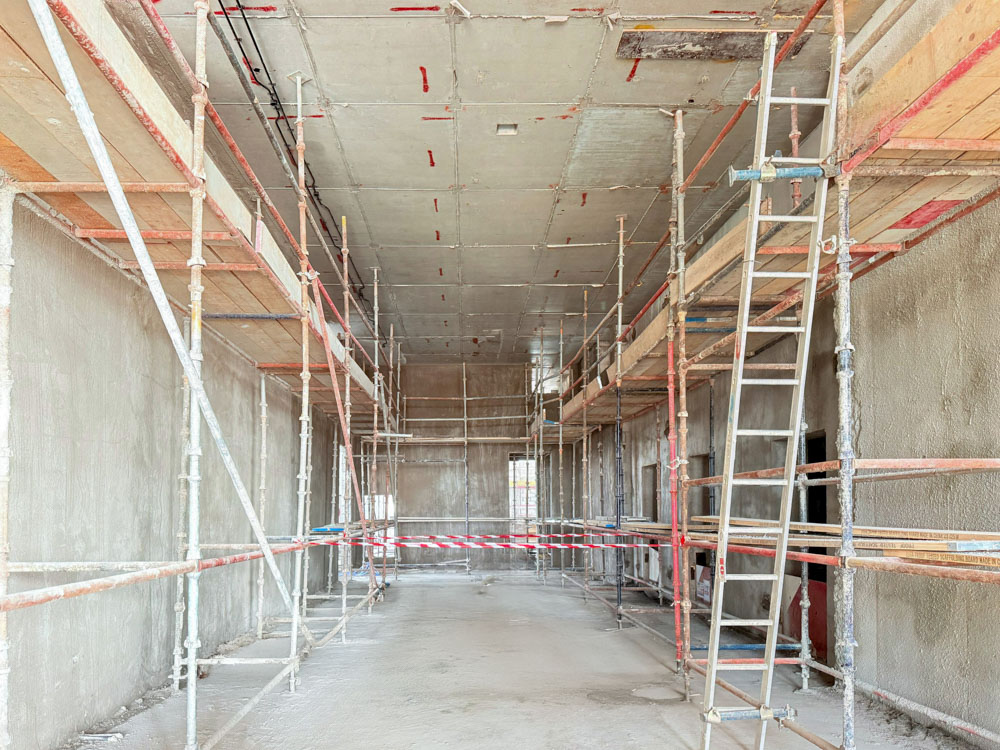 Beach Walk Iii By Imtiaz Interior construction site with scaffolding, incomplete walls, and a flat ceiling ready for finishing work.